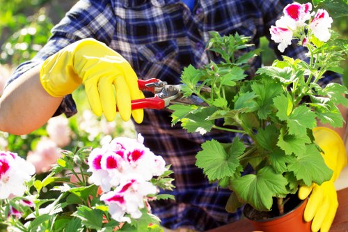 Gardening team preparing tools and wearing PPE in a garden